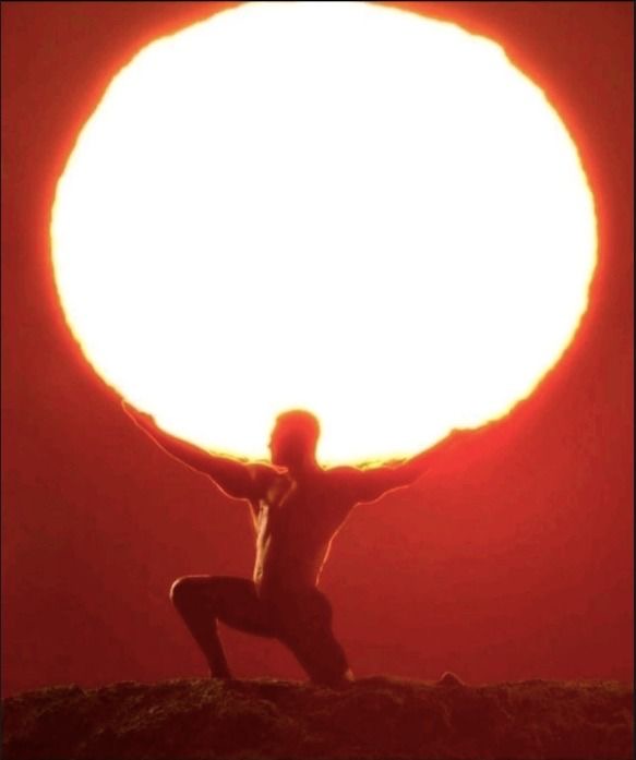 Person holding the sun overhead
