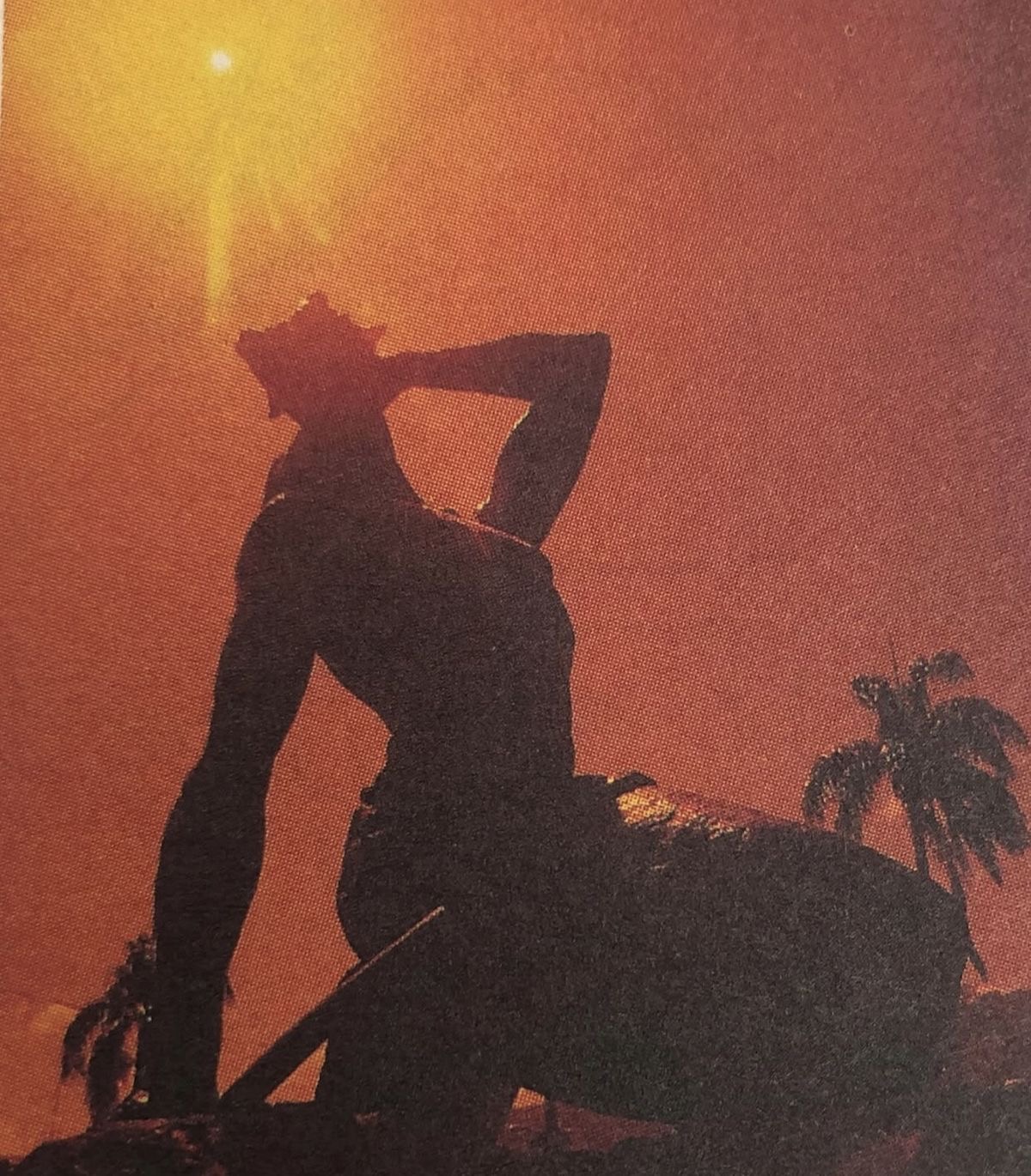 Person kneeling and blowing into a shell
